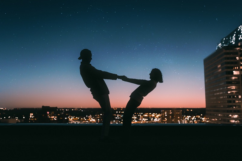 Couple holding hands in the dark - Dope Uncle