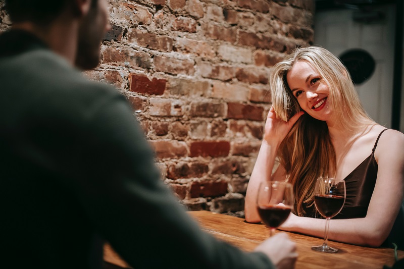 Woman playing with hair on date - Dope Uncle