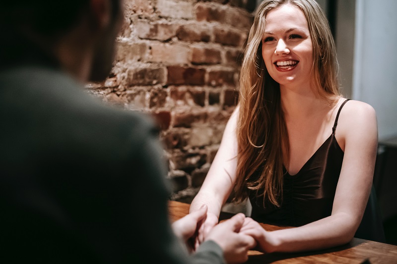 Woman smiling on date with man - Dope Uncle