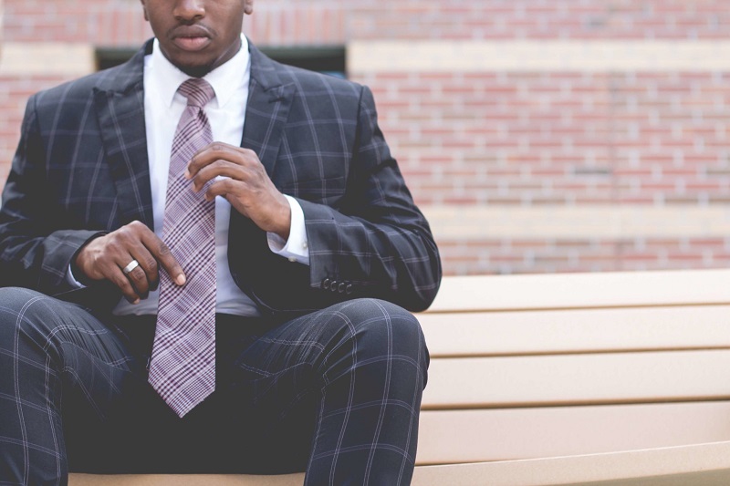 Man sitting dressed in suit - Dope Uncle