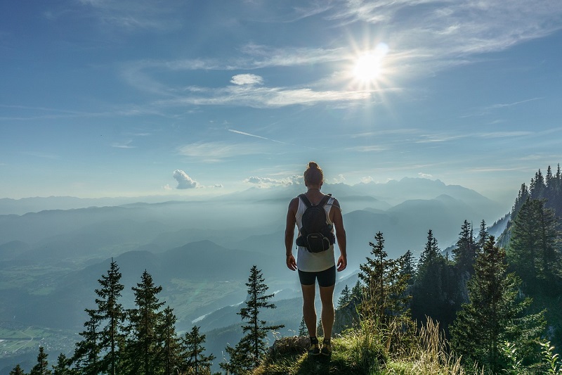 Man on mountain looking at horizon - Dope Uncle