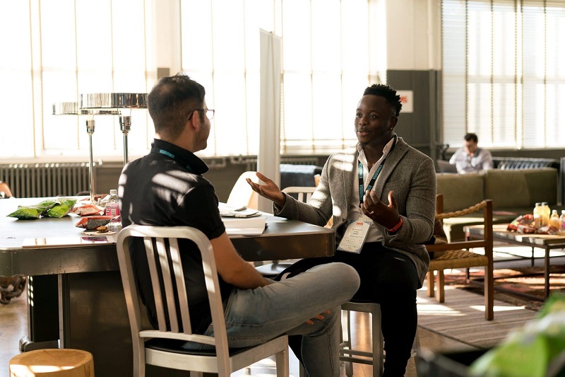 Two men sitting and talking