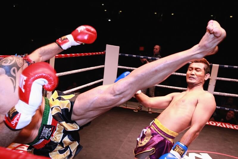 Man evading a kick in the ring